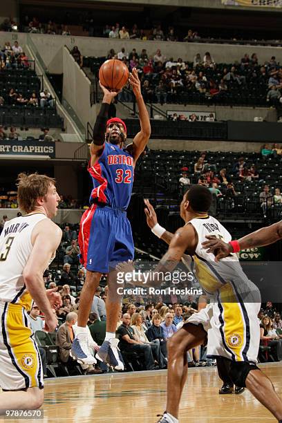 Richard Hamilton of the Detroit Pistons shoots over Brandon Rush and Troy Murphy of the Indiana Pacers at Conseco Fieldhouse on March 19, 2010 in...