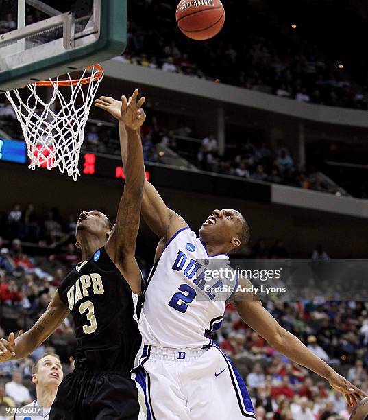 Nolan Smith of the Duke Blue Devils drives into the defense of Dominic Moore of the Arkansas-Pine Bluff Golden Lions during the first round of the...