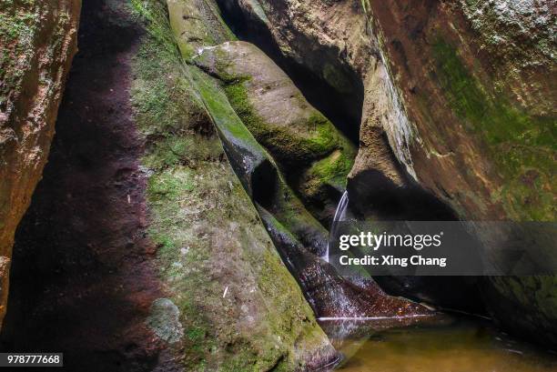 creek caves - xing stock pictures, royalty-free photos & images