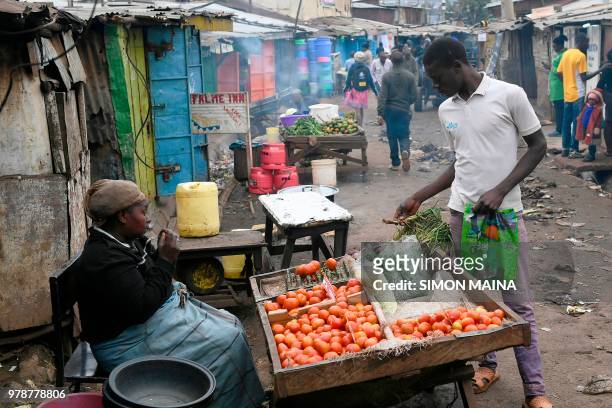 Man buys groceries in Kibera, the largest slum in the city of Nairobi, on June 19, 2018.