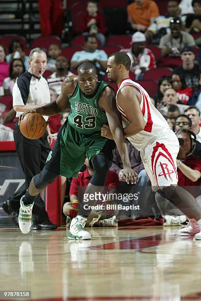 Kendrick Perkins of the Boston Celtics drives the ball past Chuck Hayes of the Houston Rockets on March 19, 2010 at the Toyota Center in Houston,...