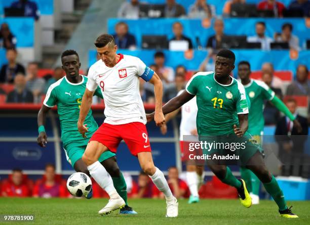 Robert Lewandowski of Poland in action against Alfred Ndiaye of Senegal during the 2018 FIFA World Cup Russia Group H match between Poland and...