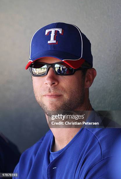 Rich Harden of the Texas Rangers sits in the dugout during the MLB spring training game against the Cleveland Indians at Surprise Stadium on March...