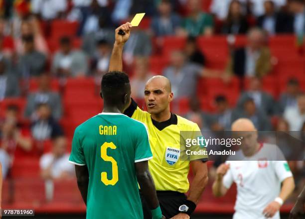 Referee shows yellow card to Idrissa Gana Gueye of Senegal during the 2018 FIFA World Cup Russia Group H match between Poland and Senegal at the...