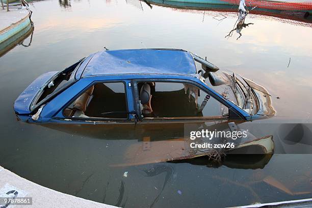 old broken car submerged in water - flood insurance stock pictures, royalty-free photos & images