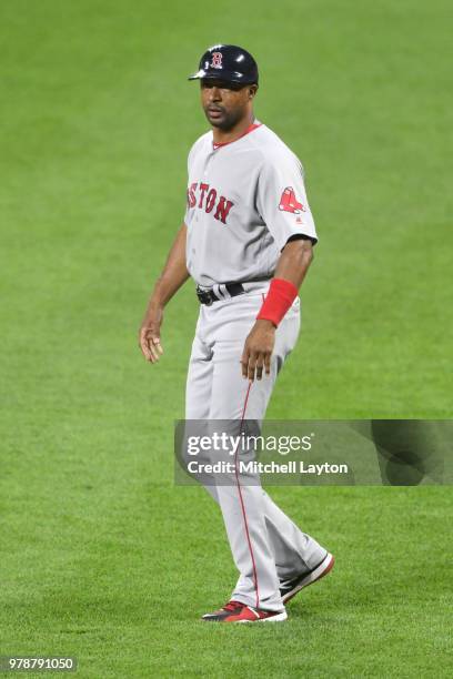 First base coach Tom Goodwin of the Boston Red Sox looks on during a baseball game against the Baltimore Orioles at Oriole Park at Camden Yards on...