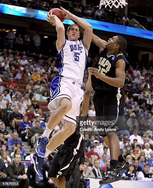 Mason Plumlee of the Duke Blue Devils shoots the ball while defended by Lebaron Weathers of the Arkansas-Pine Bluff Golden Lions during the first...