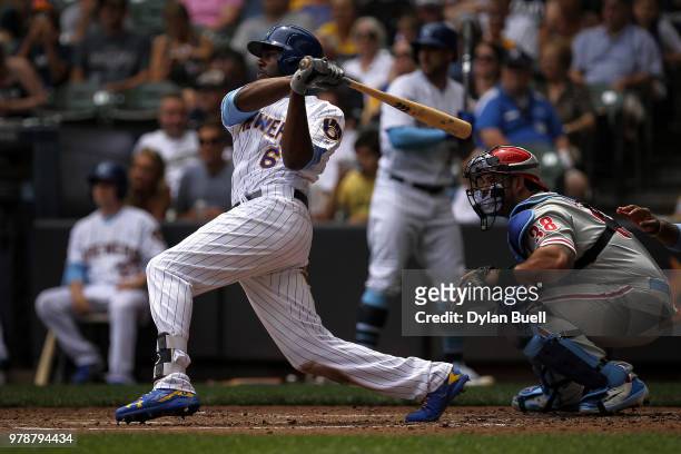Lorenzo Cain of the Milwaukee Brewers hits a double in the third inning against the Philadelphia Phillies at Miller Park on June 17, 2018 in...
