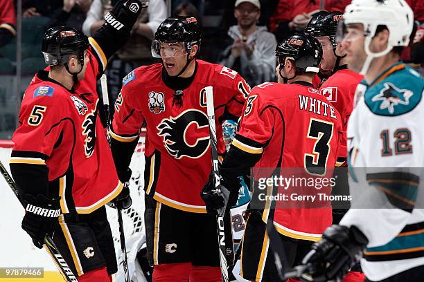 Jarome Iginla celebrates a goal with Mark Giordano and Ian White of the Calgary Flames against the San Jose Sharks on March 19, 2010 at Pengrowth...