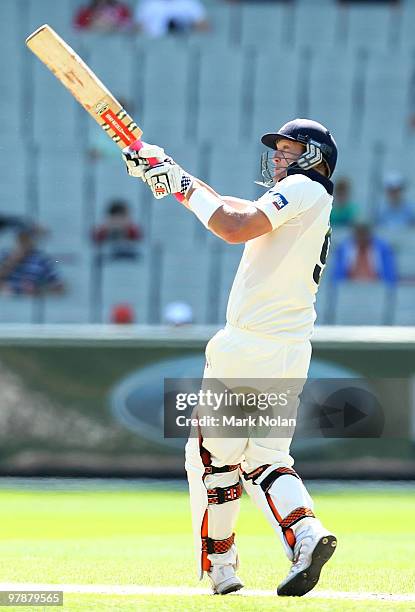 Cameron White of Victoria hits a boundary during day four of the Sheffield Shield Final between the Victorian Bushrangers and the Queensland Bulls at...