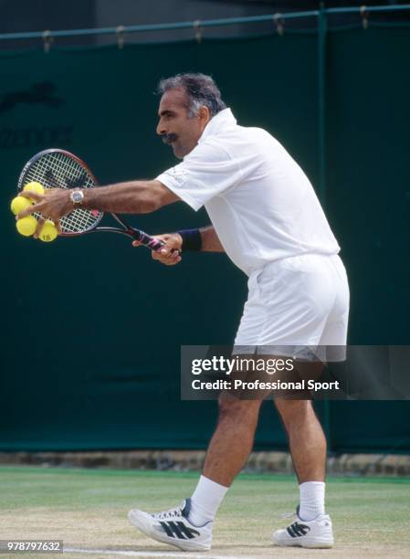 Mansour Bahrami of Iran in action during a Senior Gentleman's Invitation Doubles match in the Wimbledon Lawn Tennis Championships at the All England...