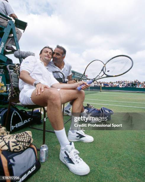 Mansour Bahrami of Iran and Henri Leconte of France pose together during a Senior Gentleman's Invitation Doubles match in the Wimbledon Lawn Tennis...