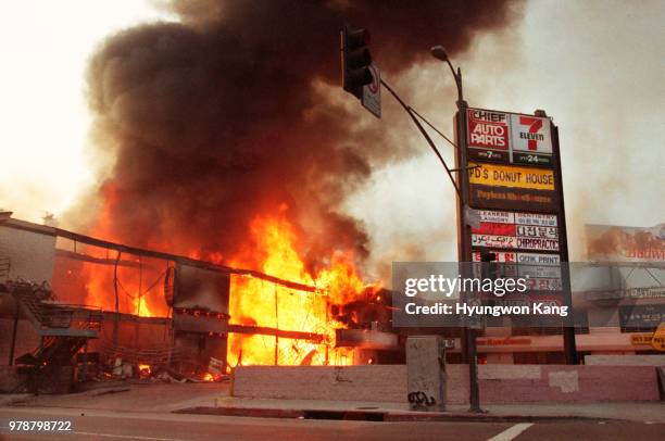 Corner shopping center at the intersection of Western Avenue & 6th Street is fully engulfed in flames as it is left burning out of control in...