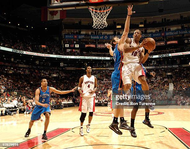 DeMar DeRozan of the Toronto Raptors takes it to the hoop against Nenad Krstic of the Oklahoma City Thunder during a game on March 19, 2010 at the...