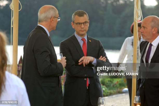 Air Liquide CEO Benoit Potier, French president's chief of staff, Alexis Kohler and Orange CEO Stephane Richard talk during a diner of the European...
