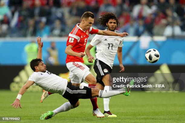 Tarek Hamed of Egypt tackles Denis Cheryshev of Russia during the 2018 FIFA World Cup Russia group A match between Russia and Egypt at Saint...