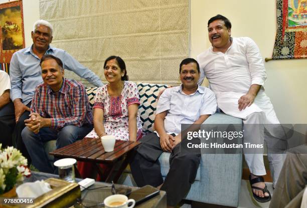 Delhi Chief Minister Arvind Kejriwal along with his wife, Health Minister Satyendra Kumar Jain and Sanjay Singh after coming out of LG's house,...