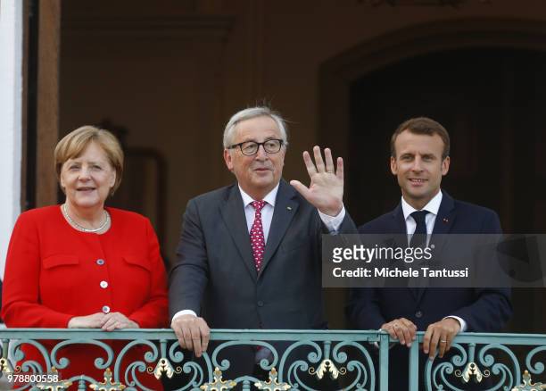 German Chancellor Angela Merkel and French President Emmanuel Macron greet EU commission president Jean-Claude Juncker at Schloss Meseberg...