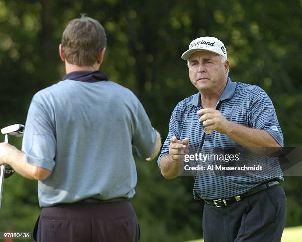 Doug Teweel shakes hands with Des Smyth leaving the 18th green after the second round at Bellerive Country Club, site of the 25th U. S. Senior Open,...