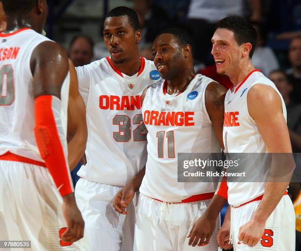 Rick Jackson, Kris Joseph, Scoop Jardine and Andy Rautins of the Syracuse Orange react after a play against the Vermont Catamounts during the first...