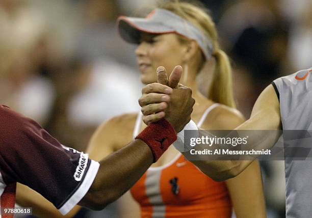 Leander Paes and Max Mirnyi shake hands after a quarter final mixed doubles match September 6, 2004 at the 2004 US Open in New York.