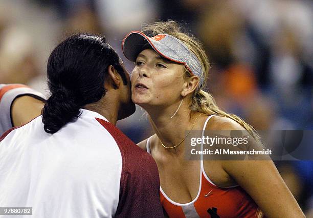 Maria Sharapova hugs winner Leander Paes after a quarter final mixed doubles match September 6, 2004 at the 2004 US Open in New York. Sharapova and...