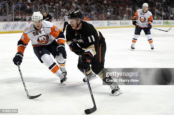 Saku Koivu of the Anaheim Ducks skates around Dustin Kohn of the New York Islanders during the first period at the Honda Center on March 19, 2010 in...