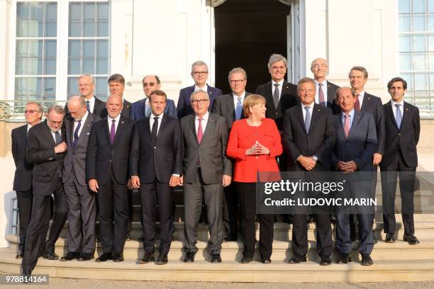 French President Emmanuel Macron , EU Commission President Jean-Claude Juncker and German Chancellor Angela Merkel pose for a family picture with...