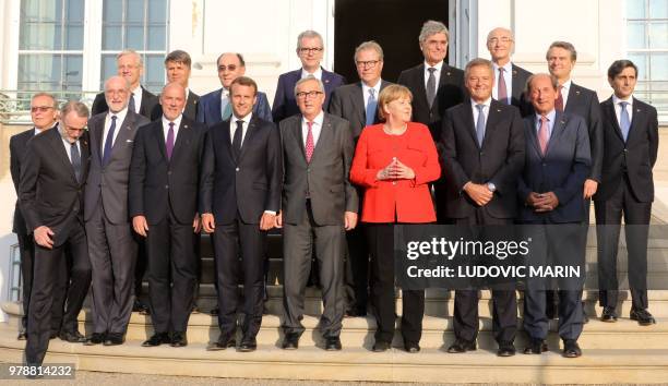 French President Emmanuel Macron , EU Commission President Jean-Claude Juncker and German Chancellor Angela Merkel pose for a family picture with...