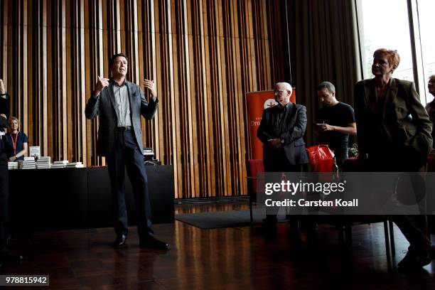 Former FBI Director James Comey talks backstage before a panel discussion about his book "A Higher Loyalty" on June 19, 2018 in Berlin, Germany....