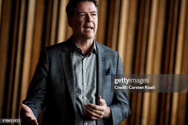 Former FBI Director James Comey talks backstage before a panel discussion about his book "A Higher Loyalty" on June 19, 2018 in Berlin, Germany....