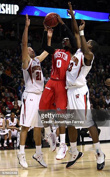 Kelvin Lewis of the Houston Cougars shoots the ball against Greivis Vasquez and Dino Gregory of the Maryland Terrapins during the first round of the...