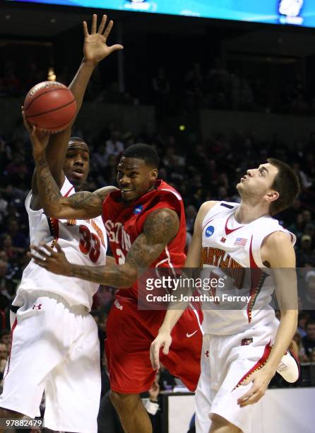 Aubrey Coleman of the Houston Cougars shoots the ball against Eric Hayes and Dino Gregory of the Maryland Terrapins during the first round of the...