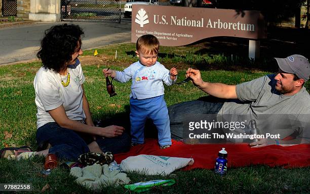 Cedar Beck, 15 months old tried to decided between his mother mother's Joy Ferrante and family friend's Peter Blank's sunglasses sitting outside the...