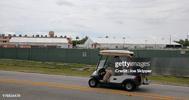 Buildings and air conditioned tents are shown as a security guard drives past in the Homestead Temporary Shelter For Unaccompanied Children on June...