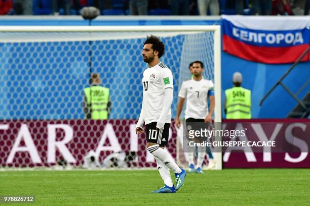 Egypt's forward Mohamed Salah reacts after Egypt's defender Ahmed Fathi own goal during the Russia 2018 World Cup Group A football match between...