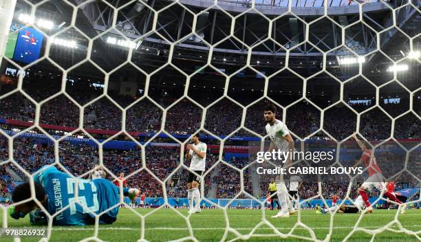 Egypt's goalkeeper Mohamed El Shenawy fails to stop the deflected shot of Russia's midfielder Aleksandr Golovin that went in off Egypt's defender...