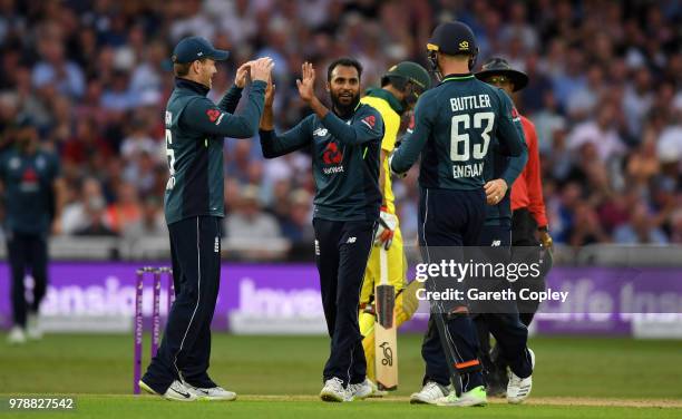 Adil Rashid of England celebrates with teammates Eoin Morgan and Jos Buttler after dismissing Tim Paine of Australia during the 3rd Royal London ODI...