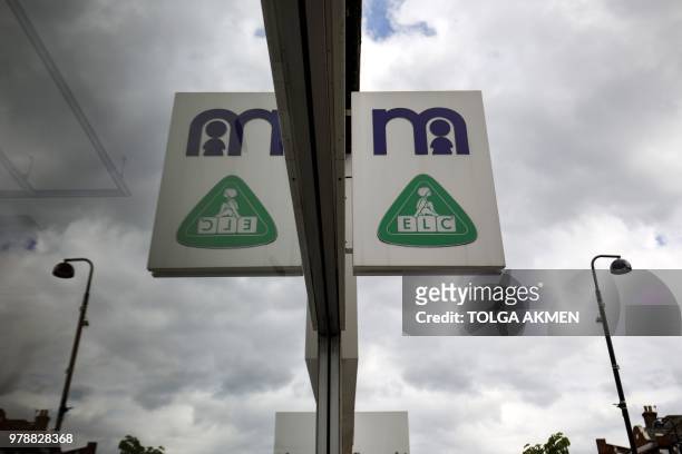Signage is pictured at a Mothercare shop on Wood Green High Street in north London on June 19, 2018. - Major UK retailers are increasingly facing...