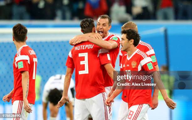 Artem Dzyuba of Russia celebrates with teammates after scoring his team's third goal during the 2018 FIFA World Cup Russia group A match between...