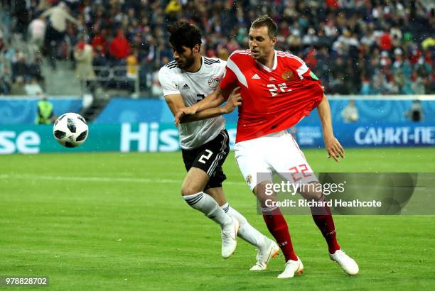 Ali Gabr of Egypt and Artem Dzyuba of Russia compete for the ball during the 2018 FIFA World Cup Russia group A match between Russia and Egypt at...