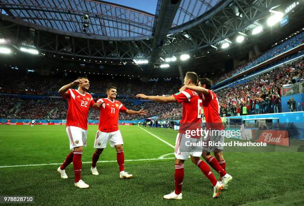 Denis Cheryshev of Russia celebrates with teammates after scoring his team's second goal during the 2018 FIFA World Cup Russia group A match between...