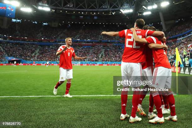 Denis Cheryshev of Russia celebrates with teammates after scoring his team's second goal during the 2018 FIFA World Cup Russia group A match between...