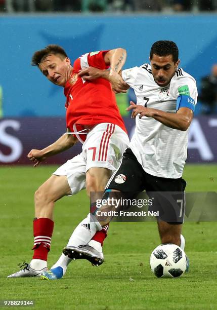 Ahmed Fathi of Egypt is tackled by Aleksandr Golovin of Russia during the 2018 FIFA World Cup Russia group A match between Russia and Egypt at Saint...