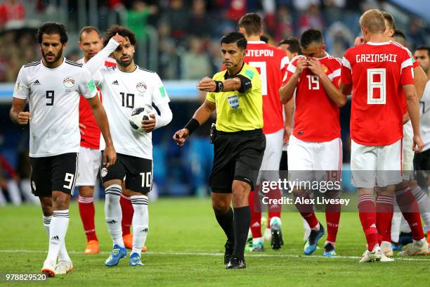 Referee Enrique Caceres gives a penalty after consulting VAR during the 2018 FIFA World Cup Russia group A match between Russia and Egypt at Saint...