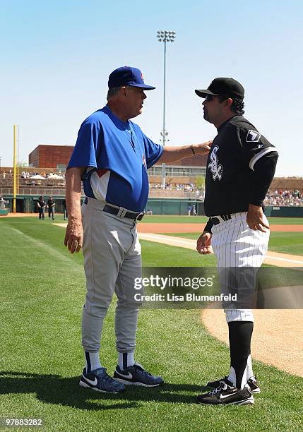Manager Lou Piniella of the Chicago Cubs talks with manager Ozzie Guillen of the Chicago White Sox before a spring training game against the Chicago...
