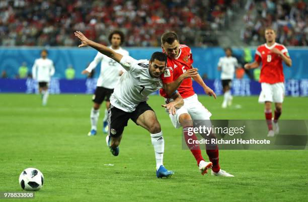 Ahmed Fathi of Egypt challenge for the ball withDenis Cheryshev of Russia during the 2018 FIFA World Cup Russia group A match between Russia and...