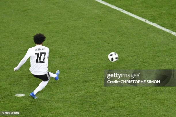 Egypt's forward Mohamed Salah shoots to score from a penalty during the Russia 2018 World Cup Group A football match between Russia and Egypt at the...