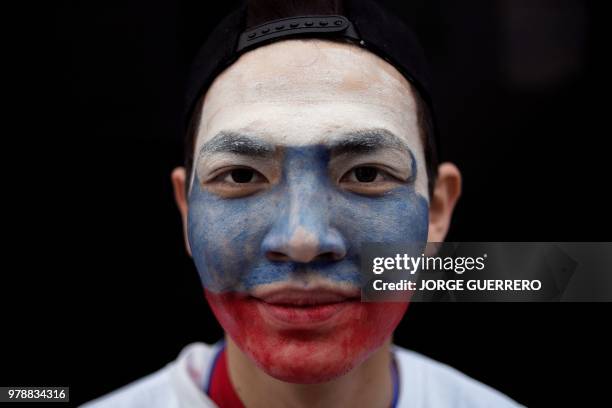 Russian fan poses for a photograph in Ekaterinburg on June 19, 2018 during the Russia 2018 World Cup football tournament.