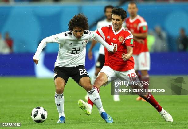 Amr Warda of Egypt and Yury Zhirkov of Russia in action during the 2018 FIFA World Cup Russia group A match between Russia and Egypt at Saint...